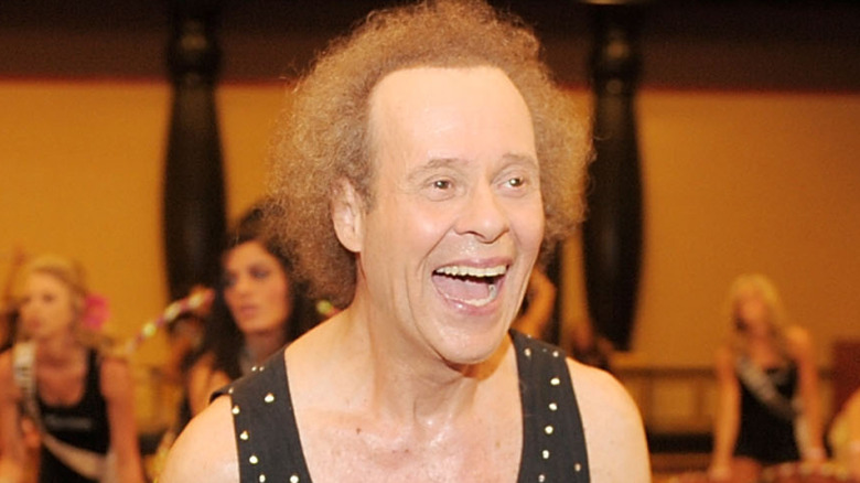 Richard Simmons laughing during hula hoop class
