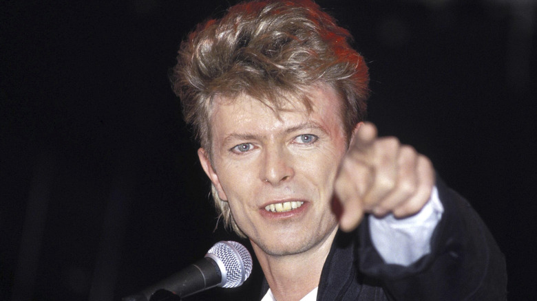 David Bowie with microphone pointing out