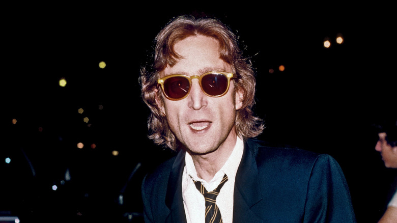 John Lennon with open mouth wearing sunglasses