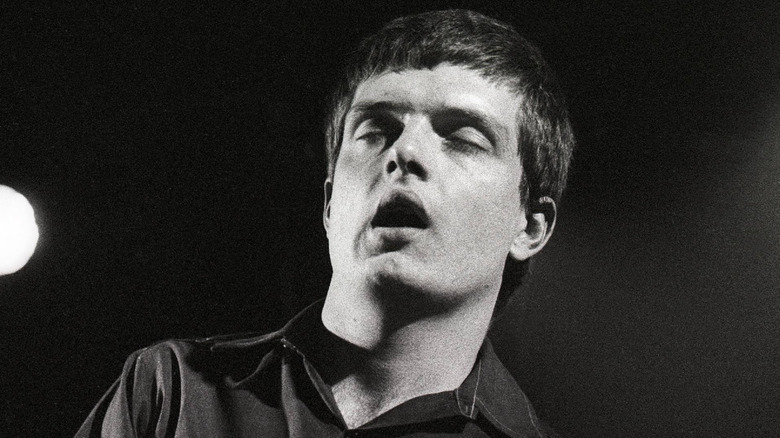 Ian Curtis eyes closed dancing on stage