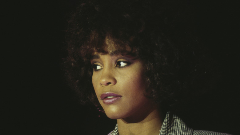 Whitney Houston in 1980s looking off