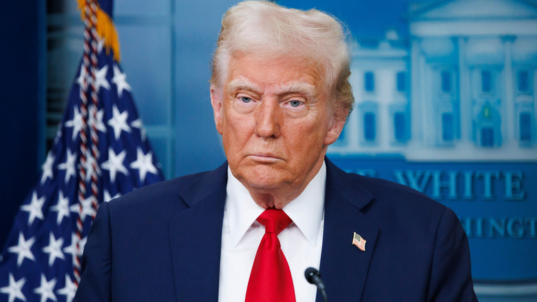Donald trump looking grumpy at a press conference