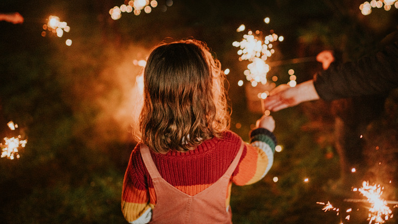 Sparkler with a background of red, white, and blue