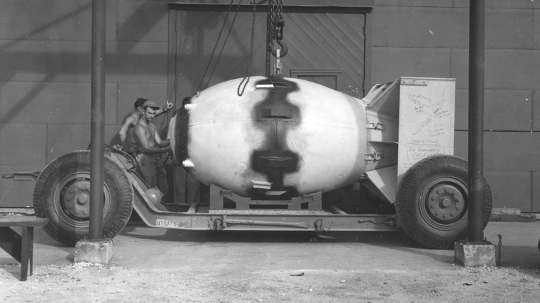 fat man bomb being lowered onto trailer cradle