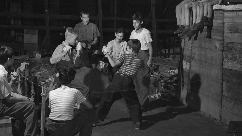 children boxing in street