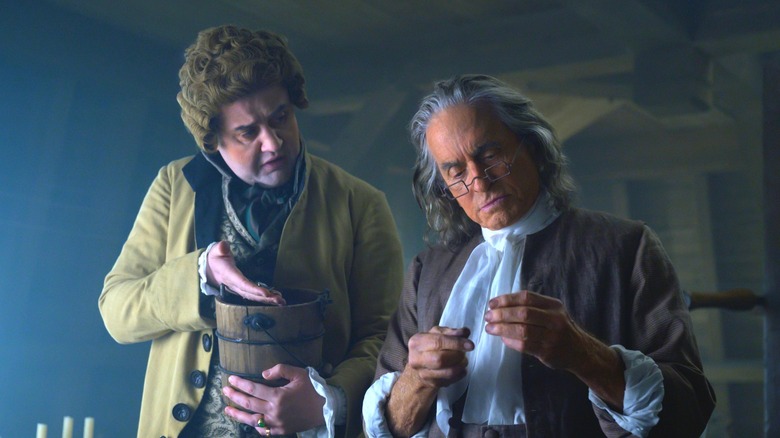 Benjamin Frankin reading letter with associate
