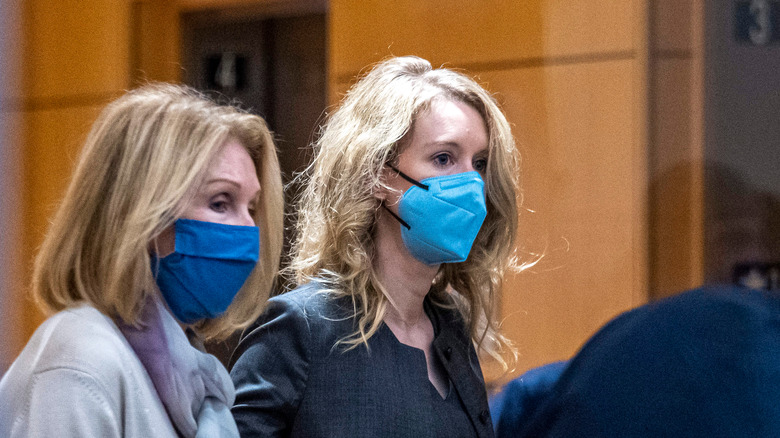 Elizabeth Holmes, masked, at trial