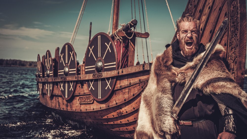 Viking standing in front of longship