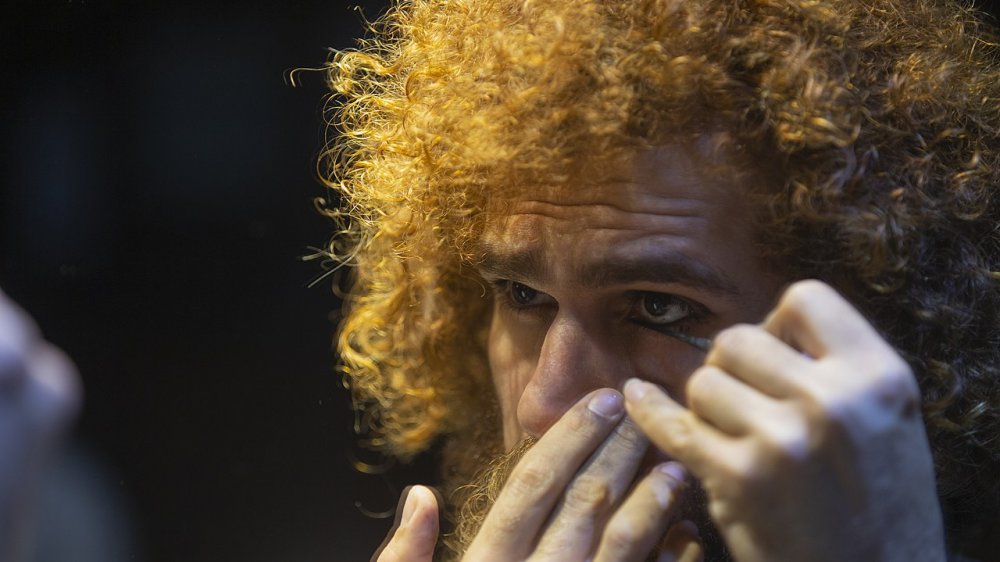 Man applying kohl eye makeup