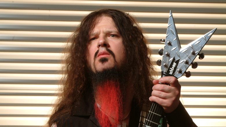 Dimebag Darrell holding his guitar in 2004