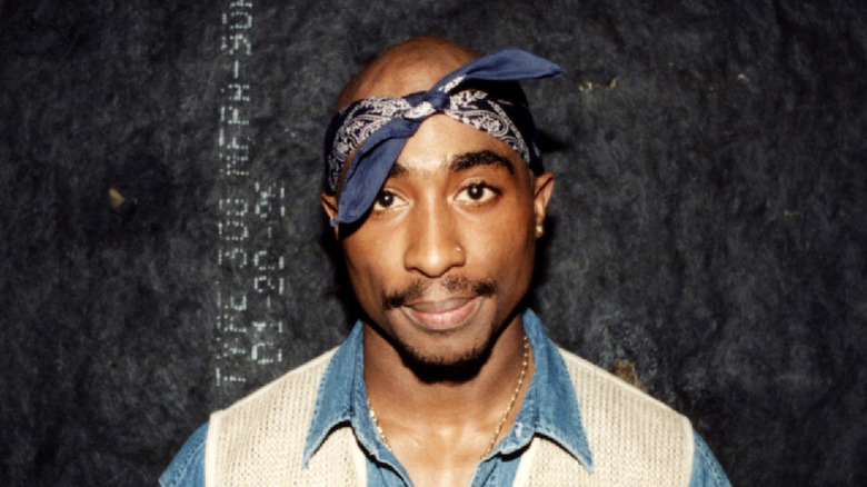 Tupac Shakur with blue bandana tied to head