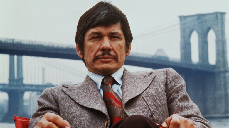 Charles Bronson sitting on a chair in 1974