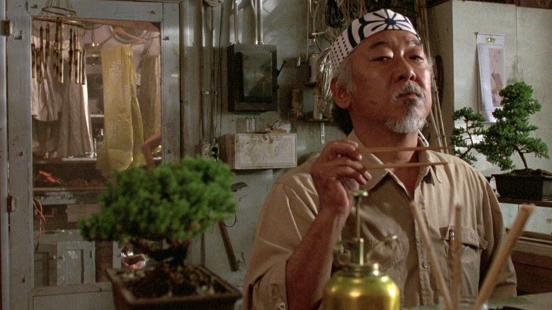 Pat Morita's Mr. Miyagi looking at the bonsai tree in The Karate Kid (1984)