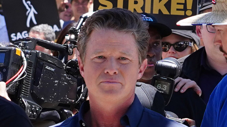 Billy Bush blue shirt in crowd of photographers