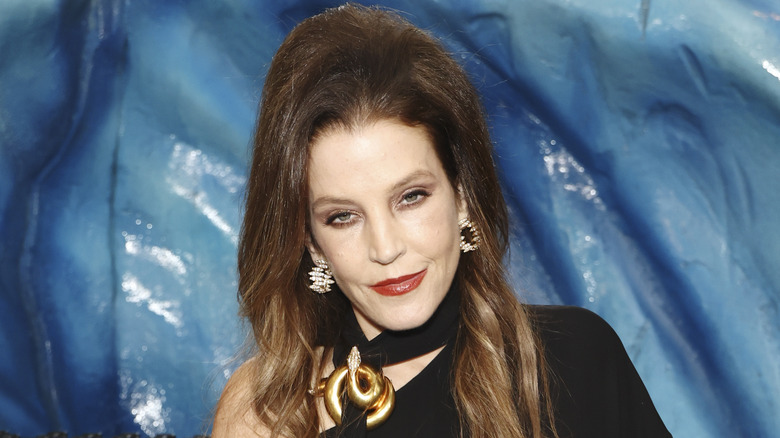 Lisa Marie Presley black dress blue background