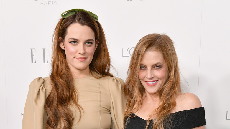 Riley Keough and Lisa Marie Presley smiling at event