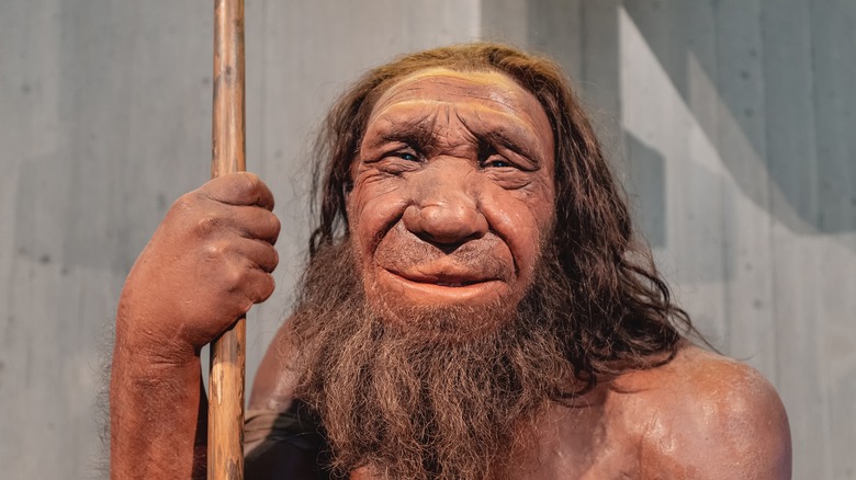 wax figure of Neanderthal man smiling