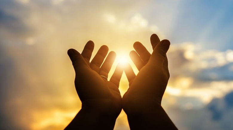 Human hands held up in worship