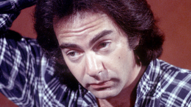 Neil Diamond scratches head and looks worried