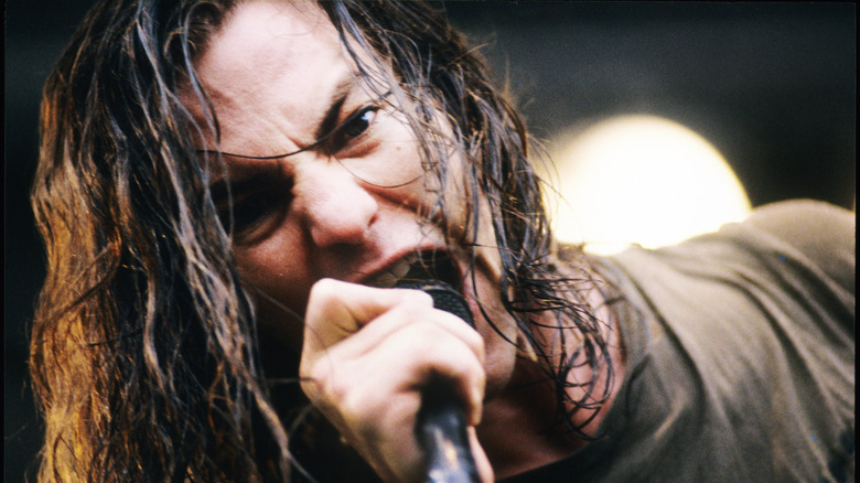 Closeup of Eddie Vedder howling into microphone