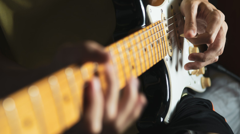 Man playing guitar left-handed