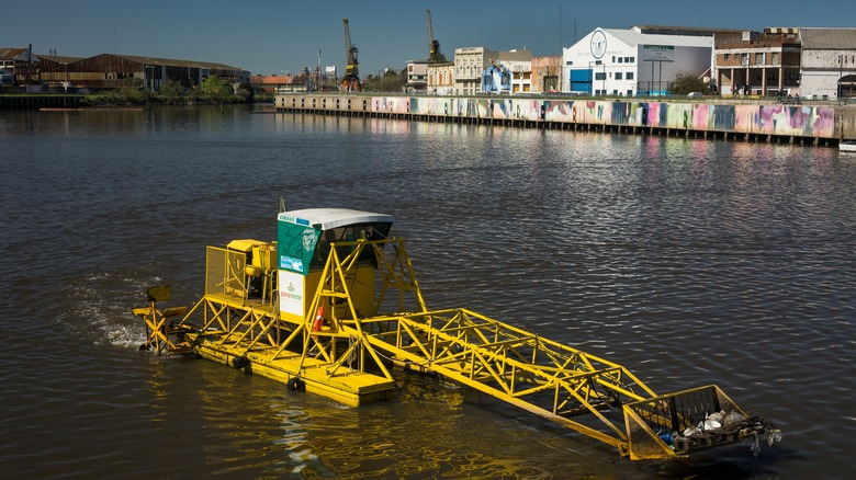 machine collecting rubbish in river