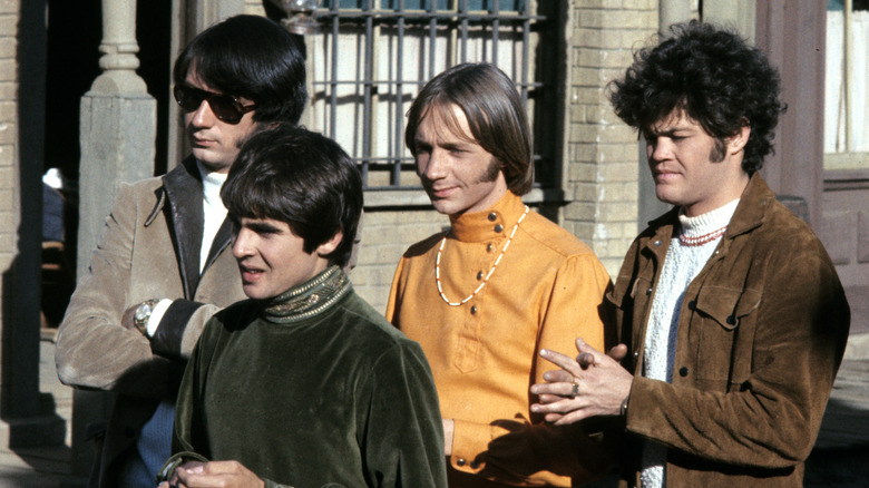 The Monkees bandmembers outside a building