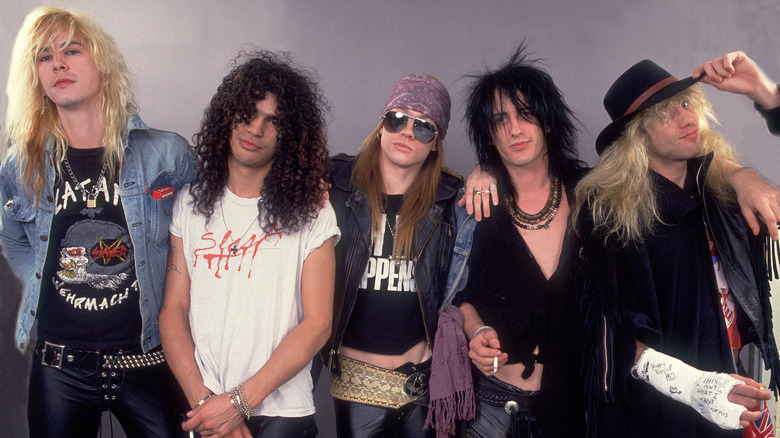 Members of Guns N' Roses (Duff McCagan, Slash, Axl Rose, Izzy Stradlin, Steven Adler) stand together in 1987