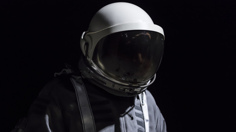 astronaut in dark helmet