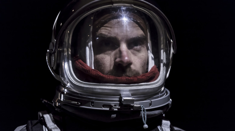 astronaut's face looking out from helmet