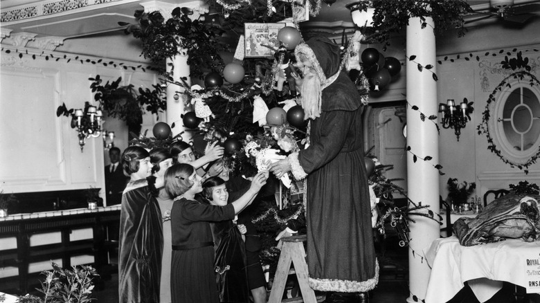 santa handing out gifts to children