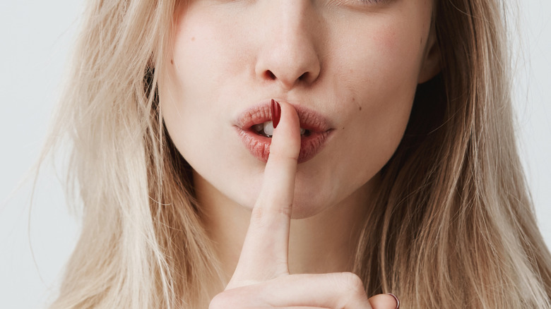 Woman saying "shh"