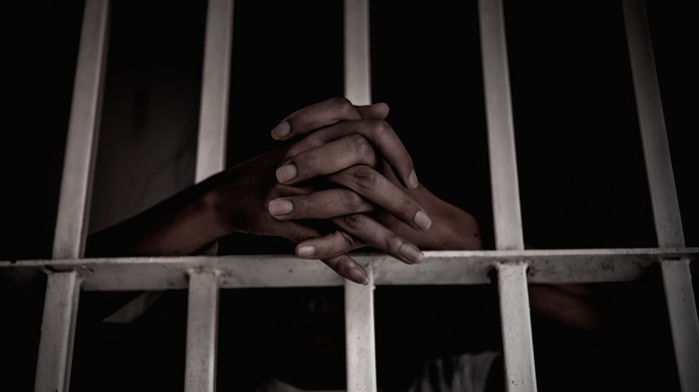 Woman's hands in jail