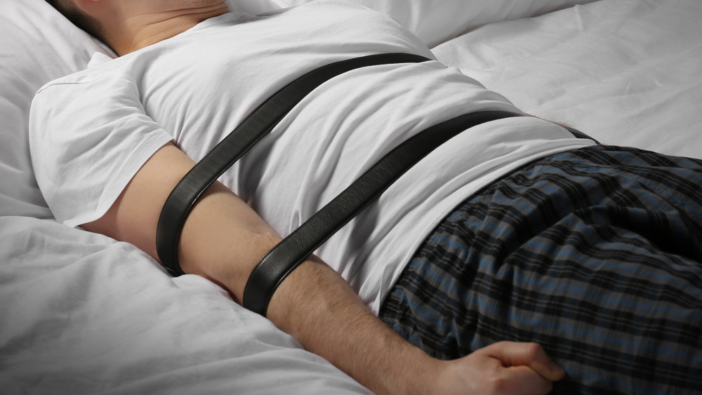 Man restrained in a bed