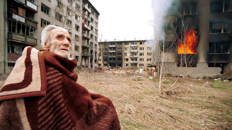 Bosnian Croat outside destroyed home