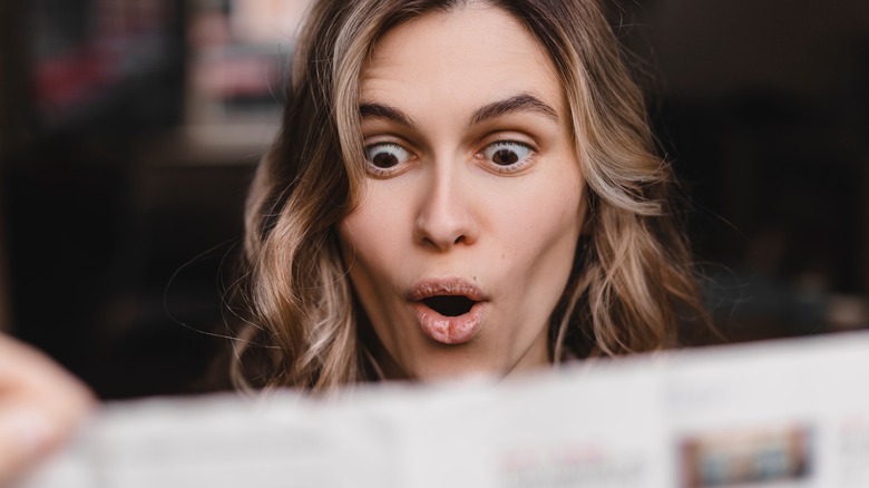 a woman reading the newspaper