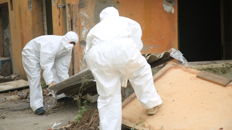 workers in protective suits
