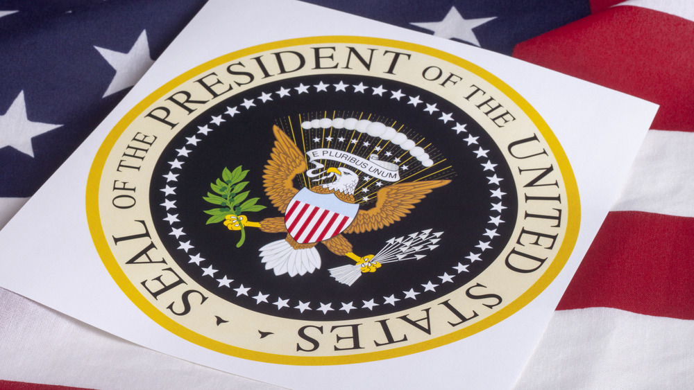 Presidential seal atop flag