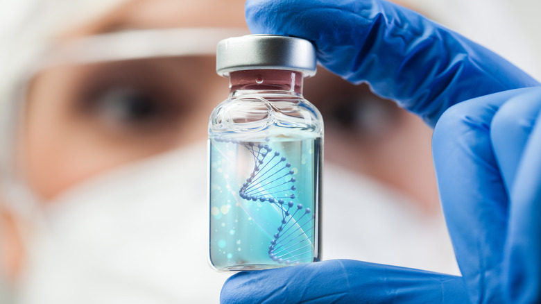 Scientist holding vial with DNA