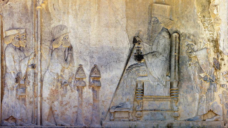 Mesopotamian-era stone relief of people before a king on a throne