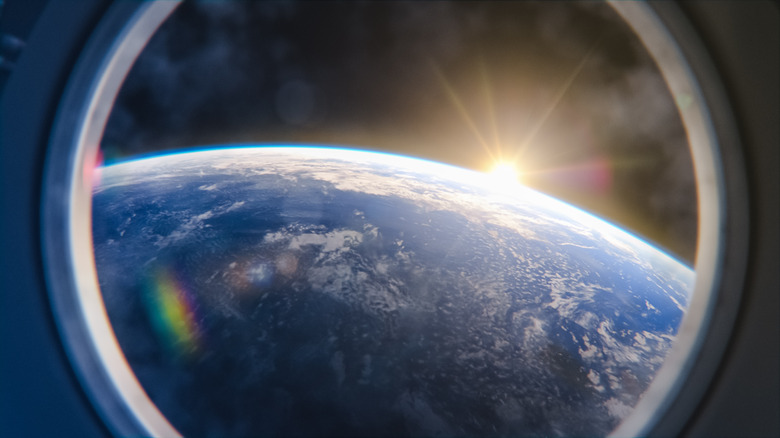 Sunrise through an ISS window