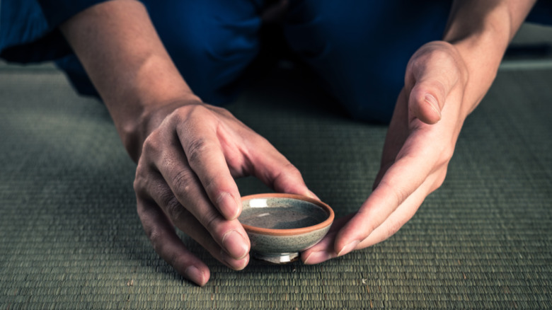 A person holds a cup