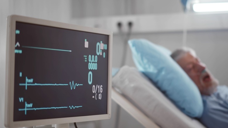 man hospital bed heart monitor