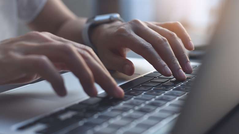 Person typing on laptop