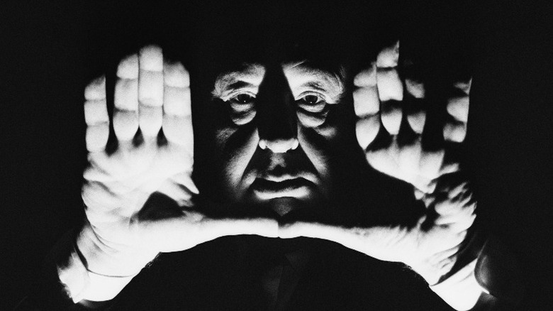 Alfred Hitchcock with hands up