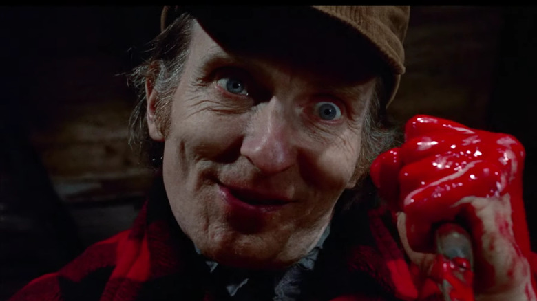 screenshot from Deranged trailer featuring actor playing Ed Gein with bloody hand