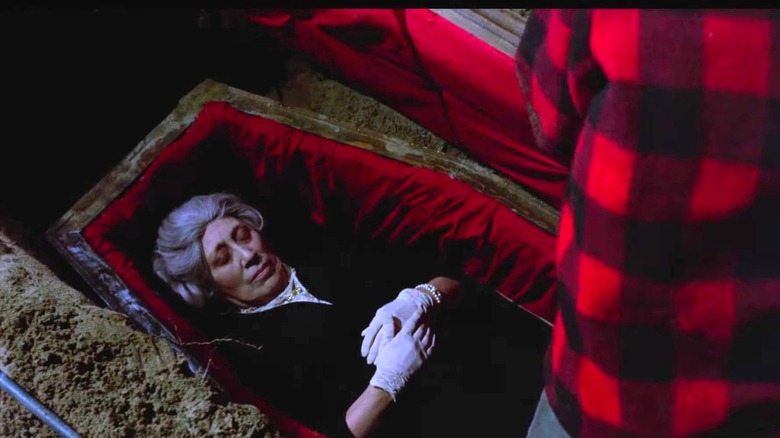 screenshot of deranged trailer with woman in open coffin
