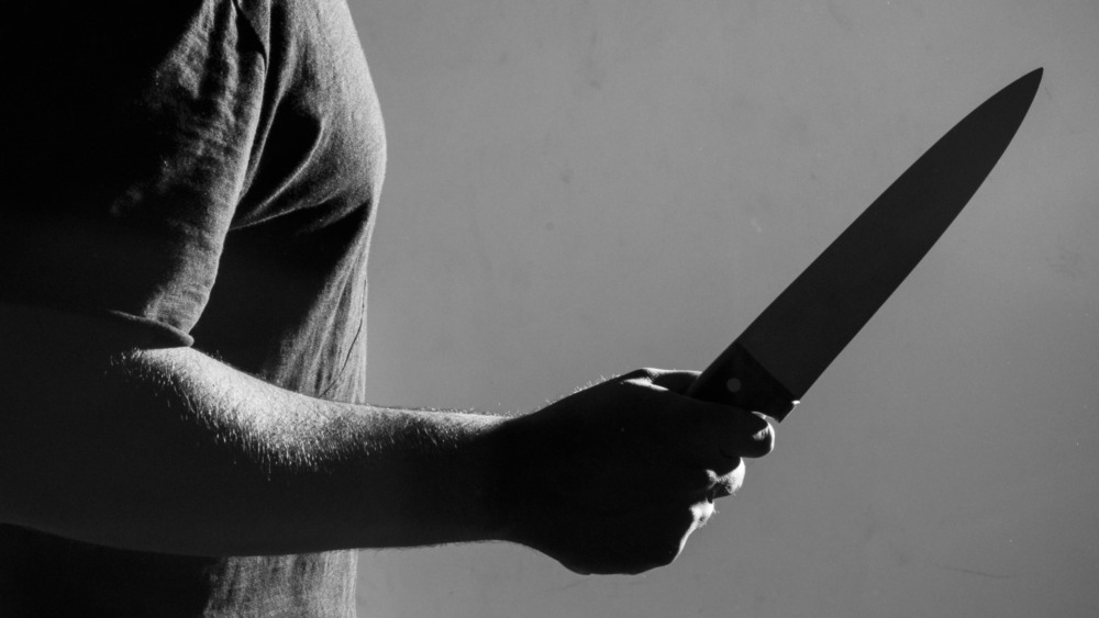 A man holds a knife.
