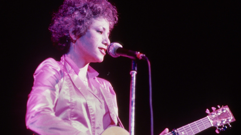 Janis Ian performing on stage with guitar in 1975