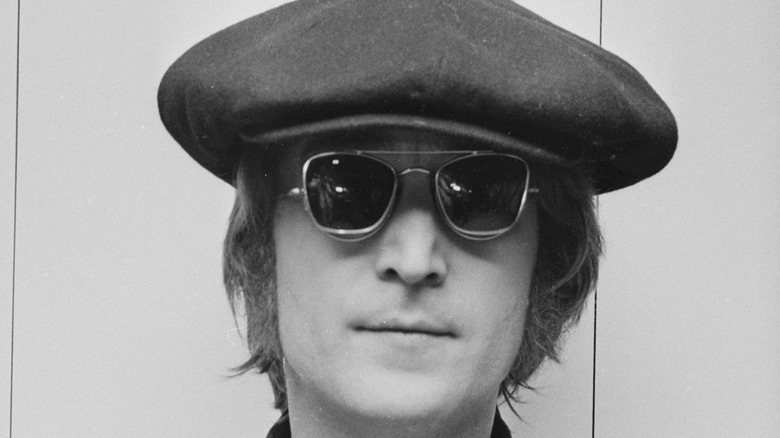 John Lennon posing for photo